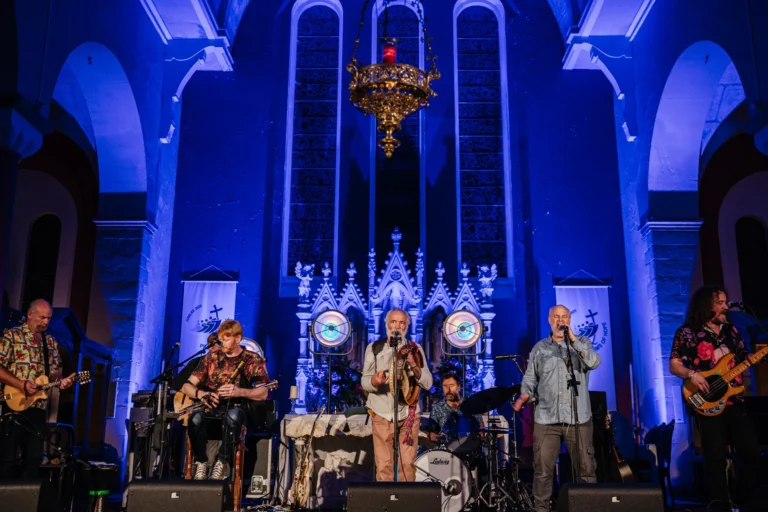 Live band performing at Mayo Dark Sky Festival in a beautifully lit church setting.